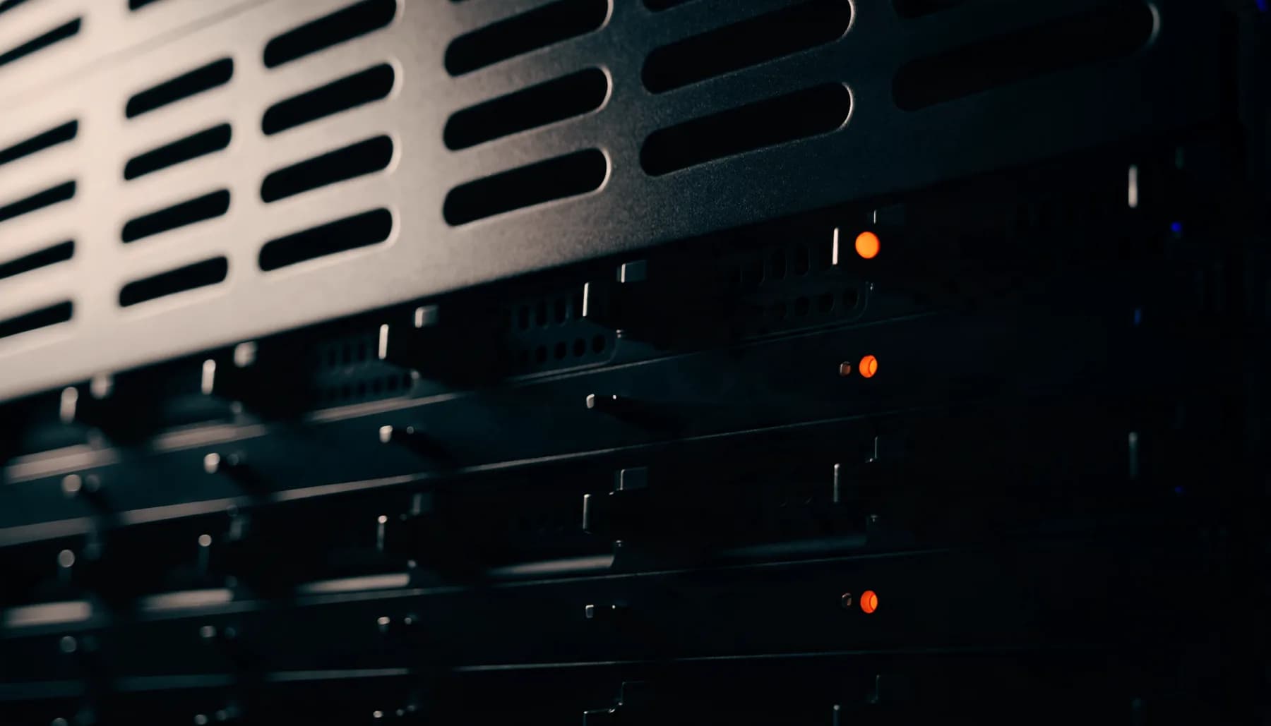 Close-up of server hardware with orange status lights